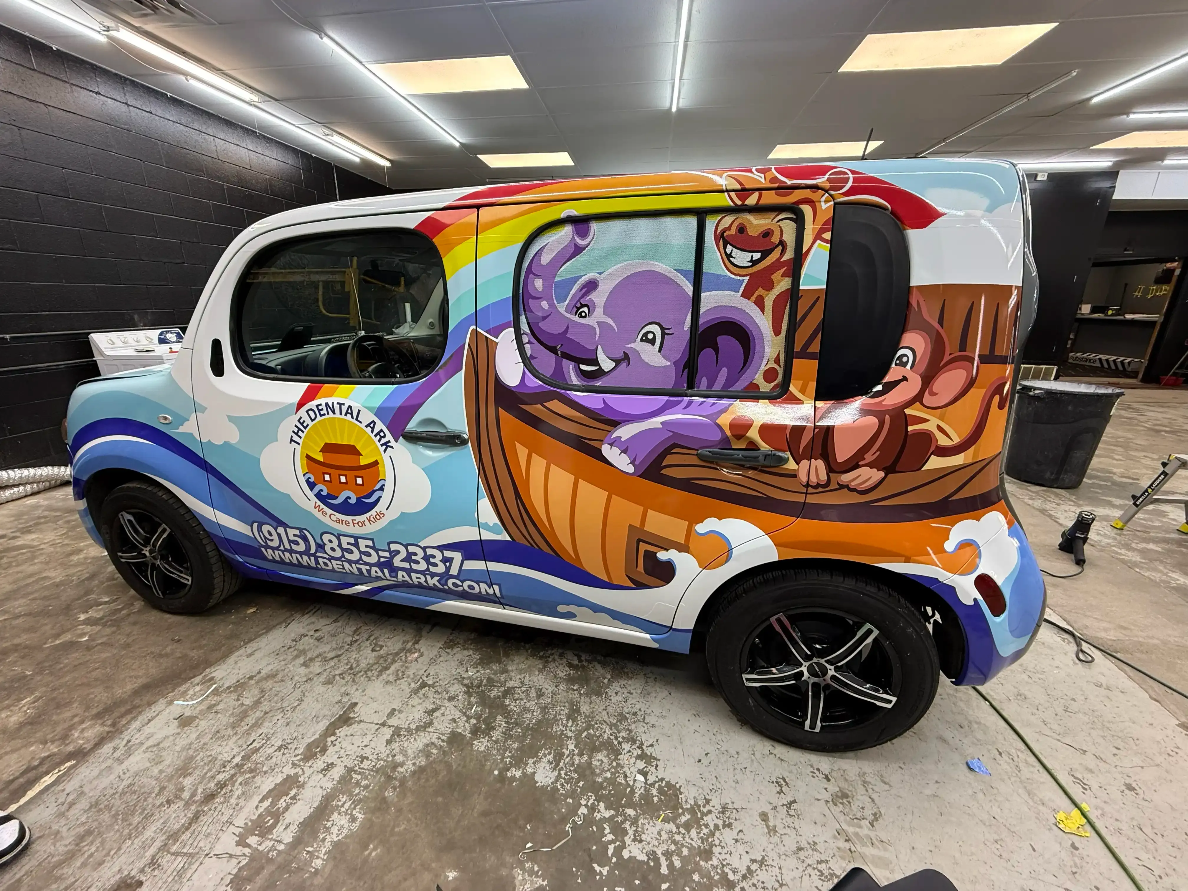 Scion xB with a full custom Dental Ark commercial vinyl wrap featuring colorful graphics and branding