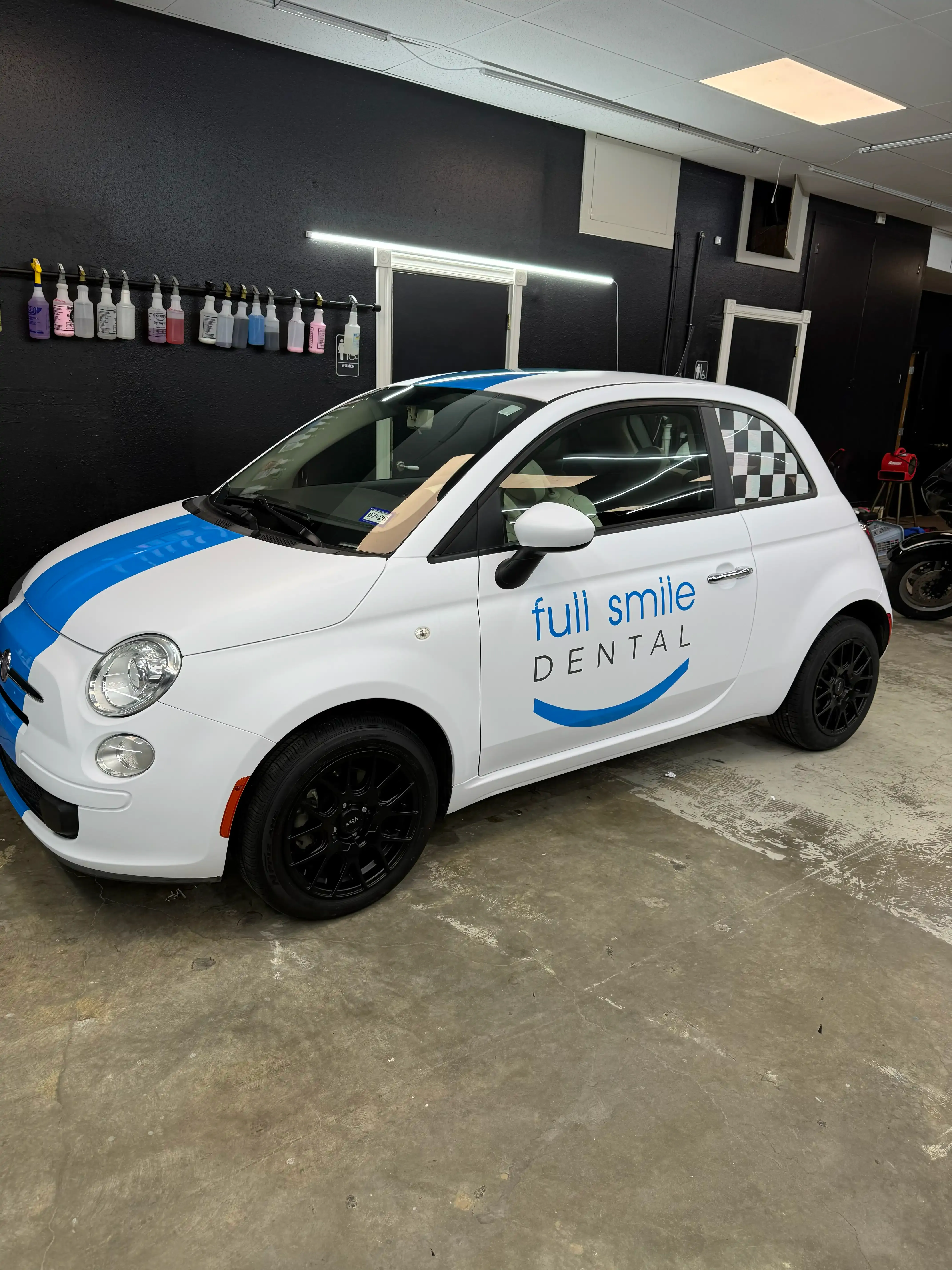 Fiat 500 with a custom Full Smile Dental commercial vinyl wrap installed by PaintSlayer AutoSpa
