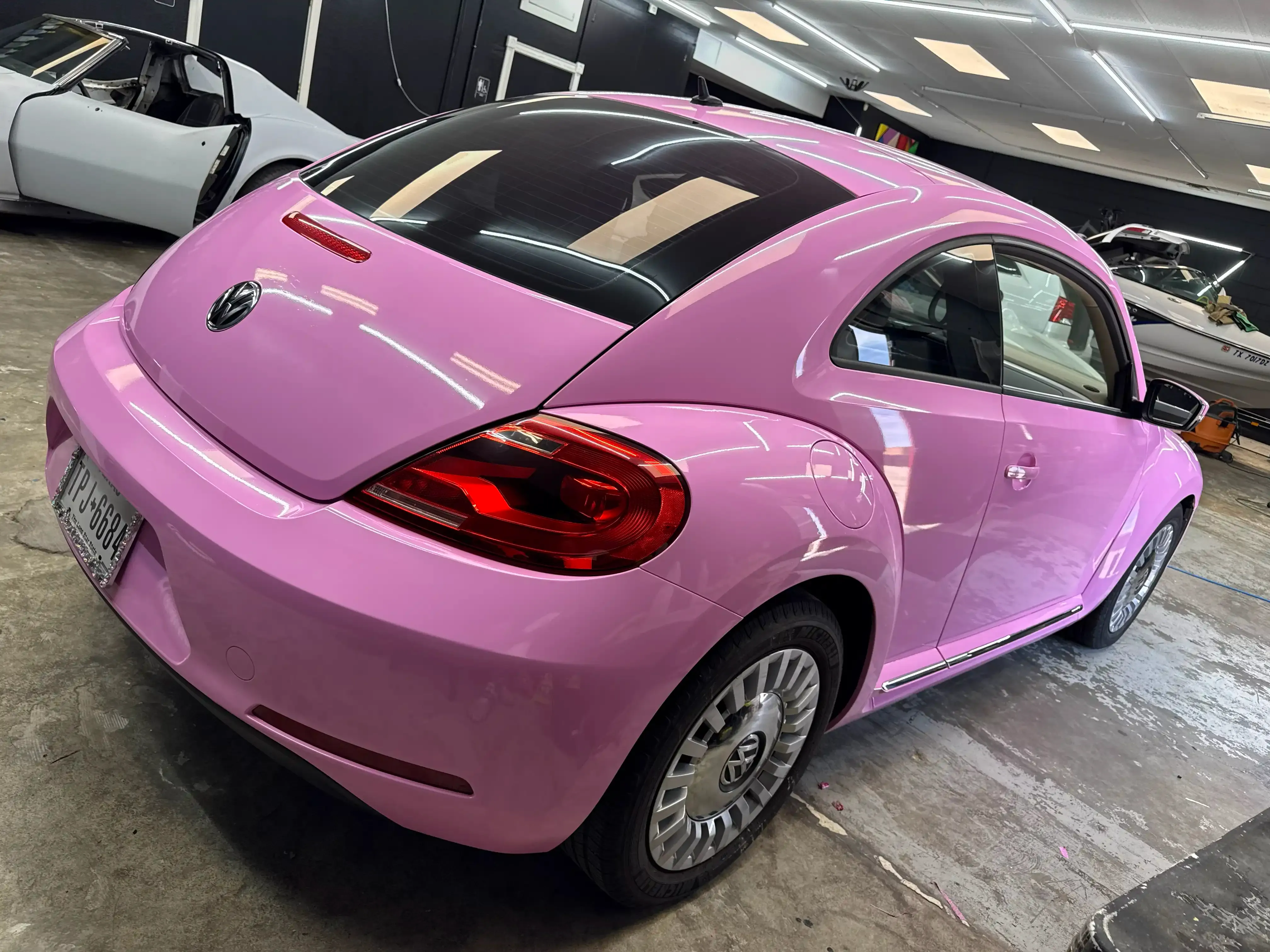 VW Beetle with a glossy pink color change vinyl wrap by PaintSlayer AutoSpa in Amarillo, TX