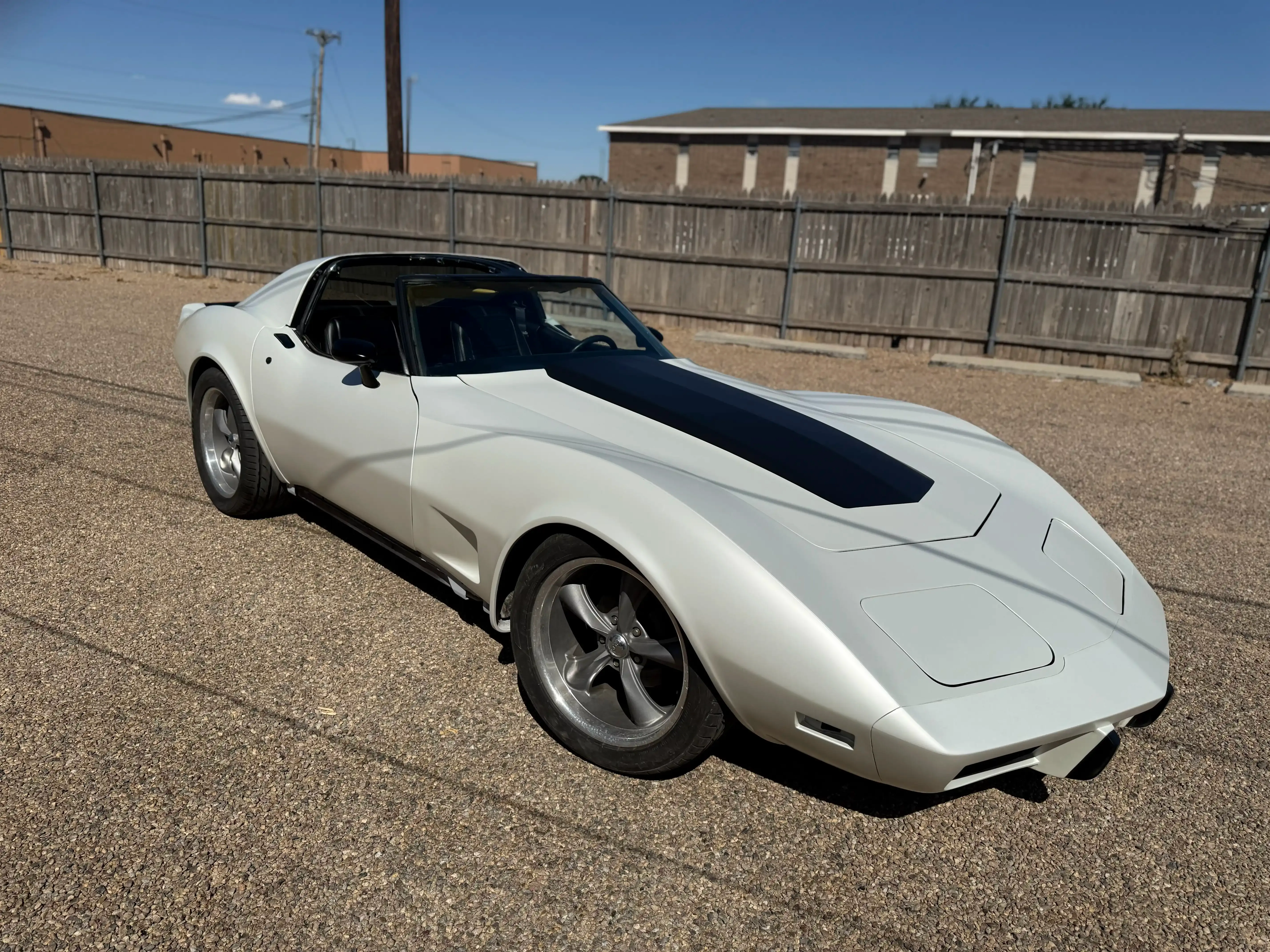 Chevrolet Corvette with a black center racing stripe vinyl accent over a light finish