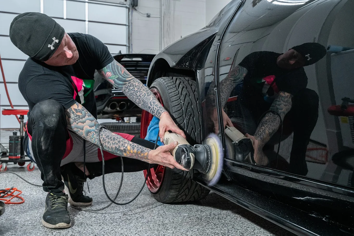 Technician machine polishing a vehicle