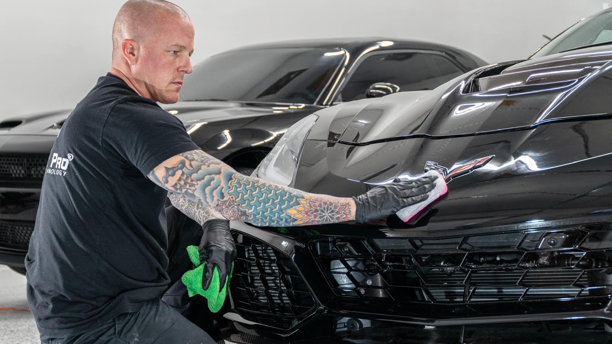 Technician applying paint protection film to vehicle
