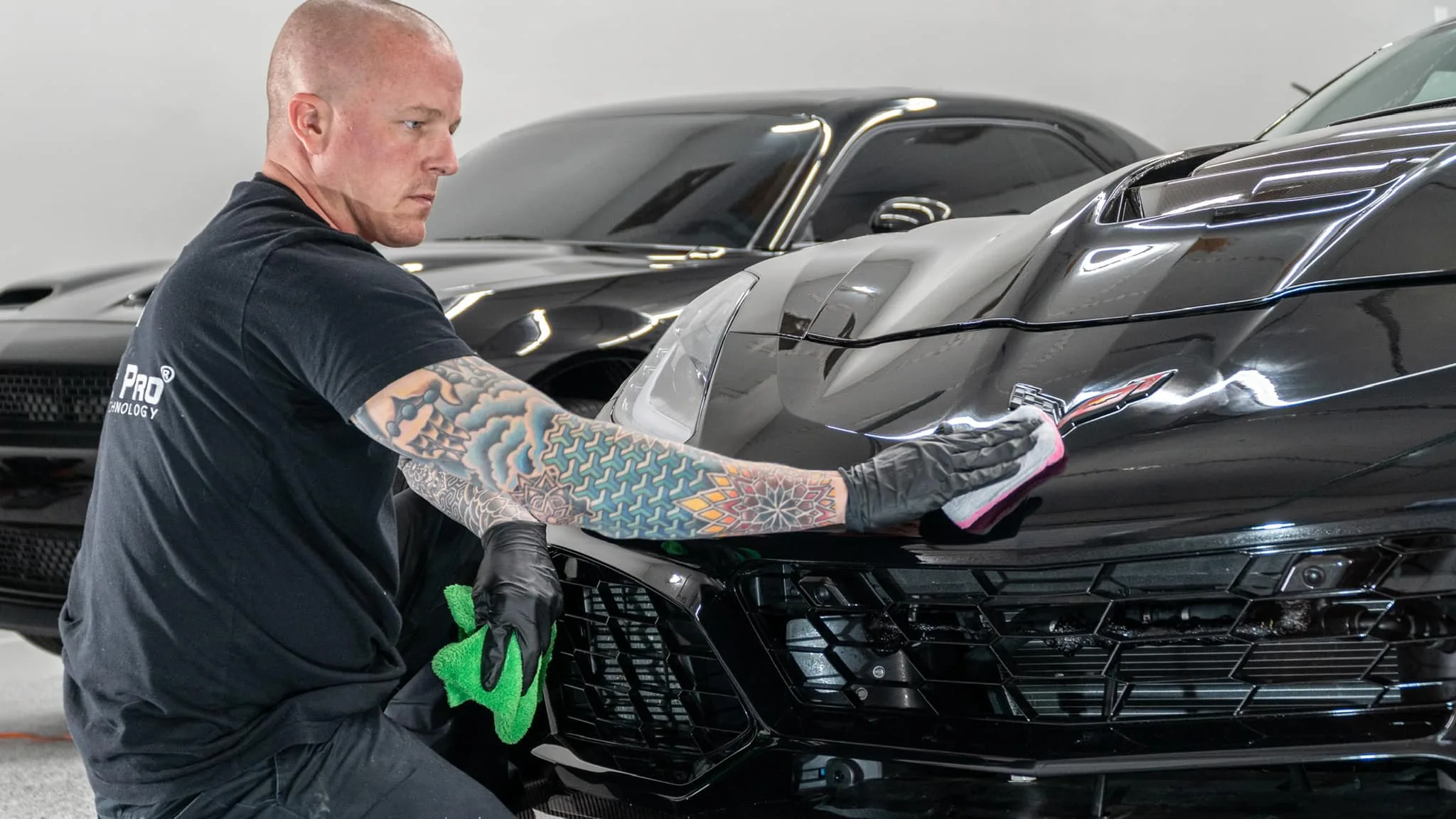 Technician applying paint protection film to vehicle
